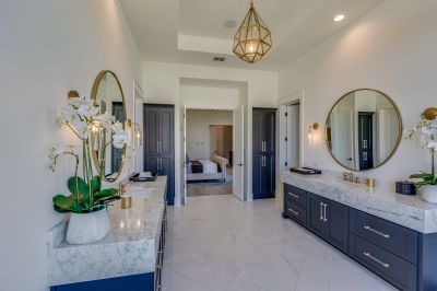 Bathroom with custom cabinetry and marble countertops
